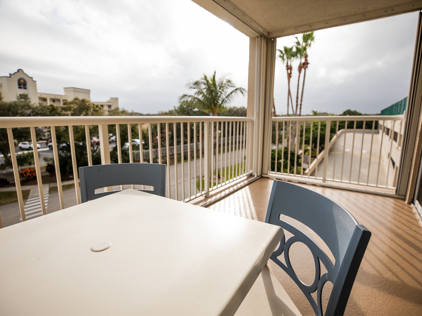 Balcony with outdoor table and chairs in a villa at Cape Canaveral Beach Resort.