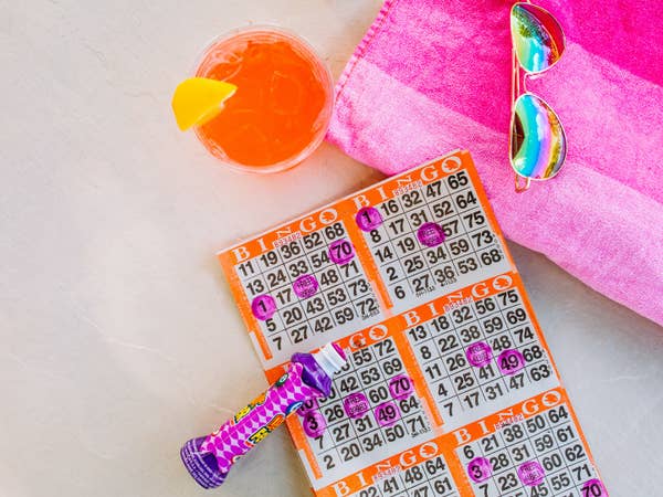 Bingo card with marker, sunglasses and drink.
