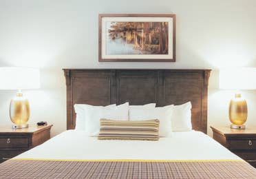 Bed with two nightstands in a villa in River Island at Orange Lake Resort near Orlando, Florida