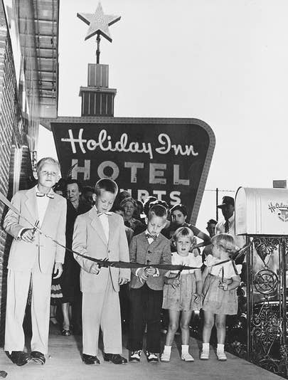 The Wilson family cutting a ribbon at a Holiday Inn