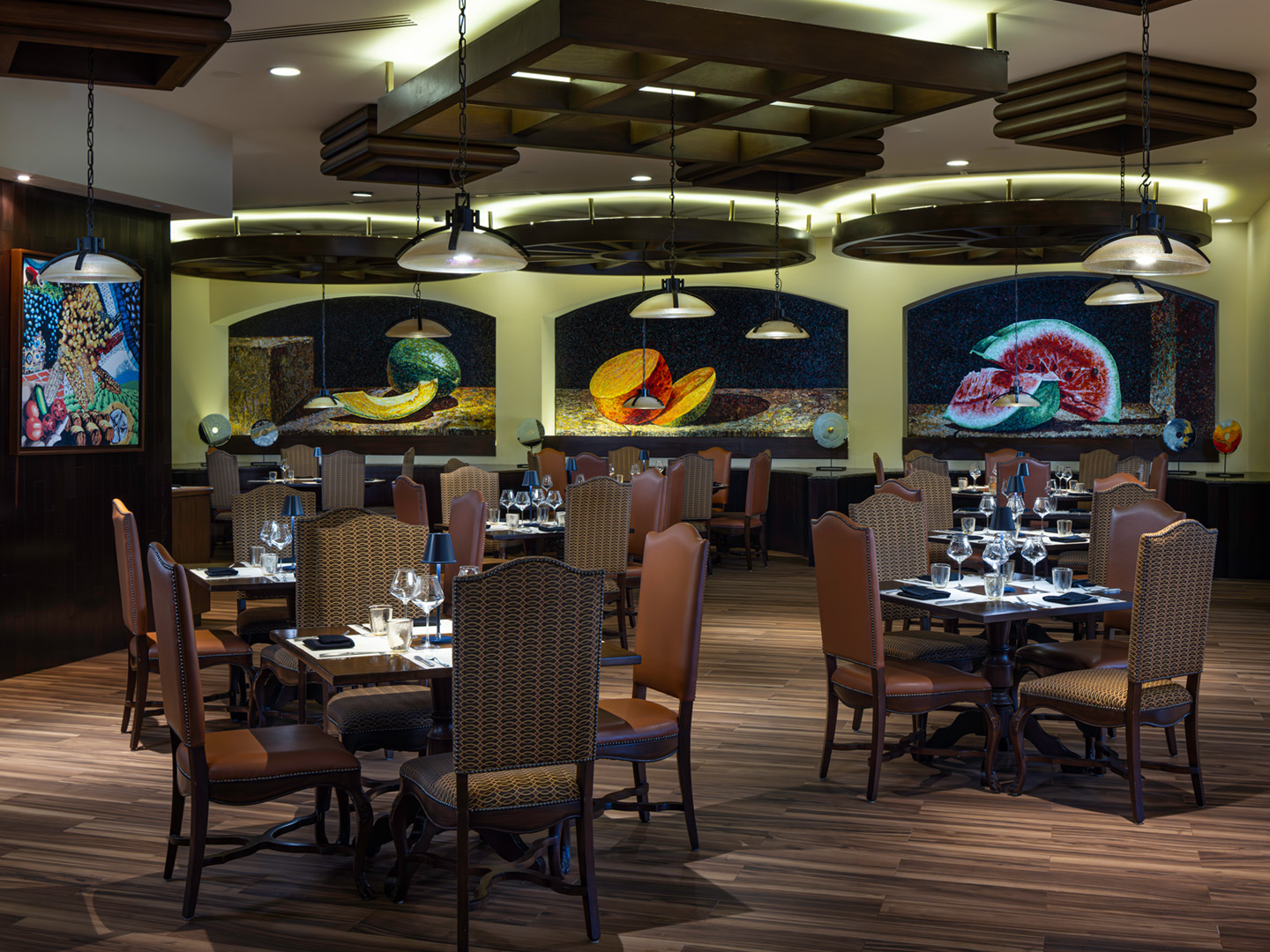 Fine dining framed by bold, expressive murals.