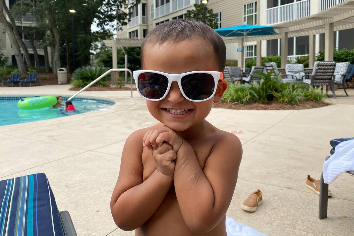 Brenda's son, Benjamin, wears white sunglasses next to mommy at the pool.