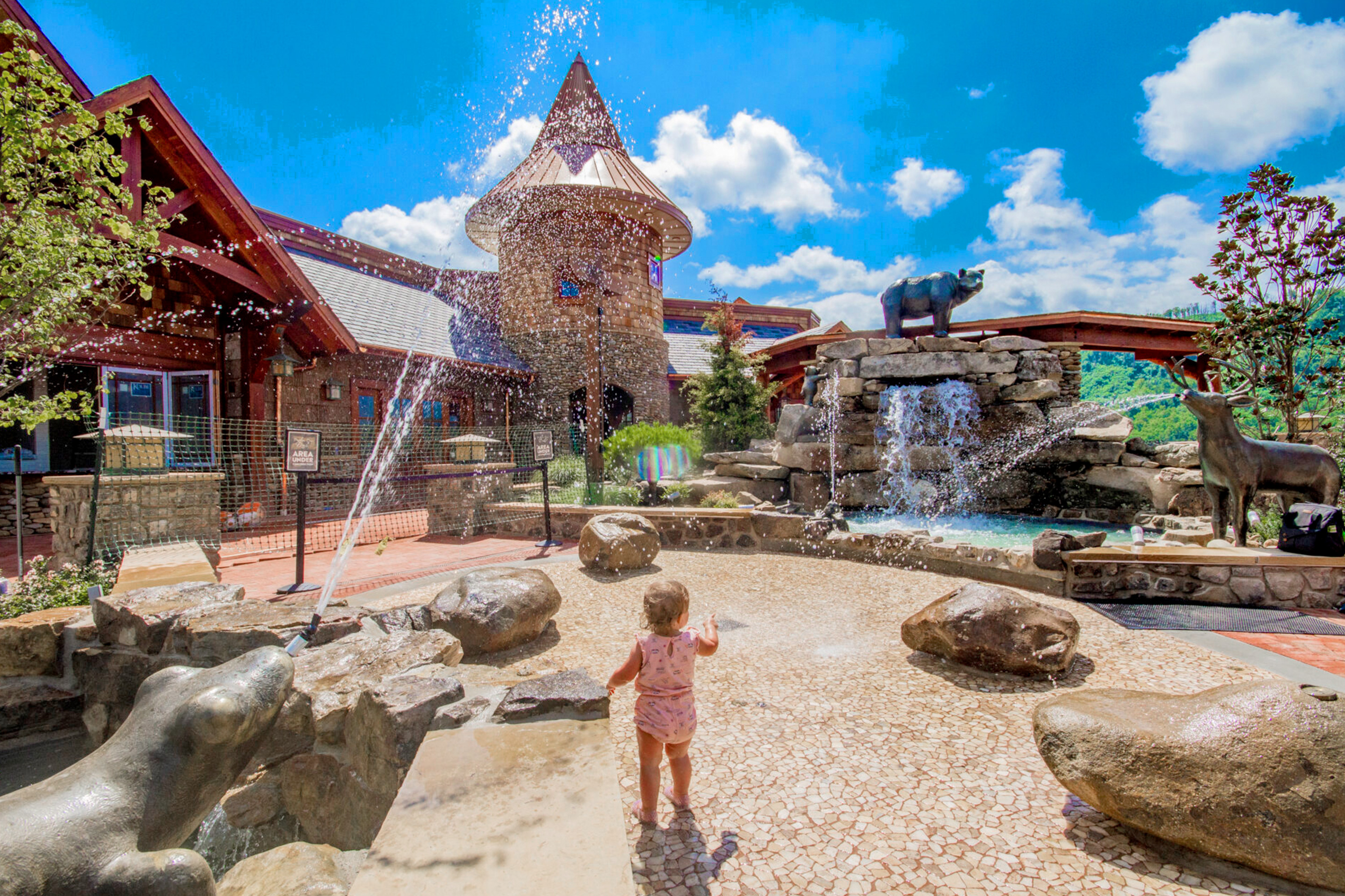 A toddler faces the splash pad at Anakeesta Theme Park.