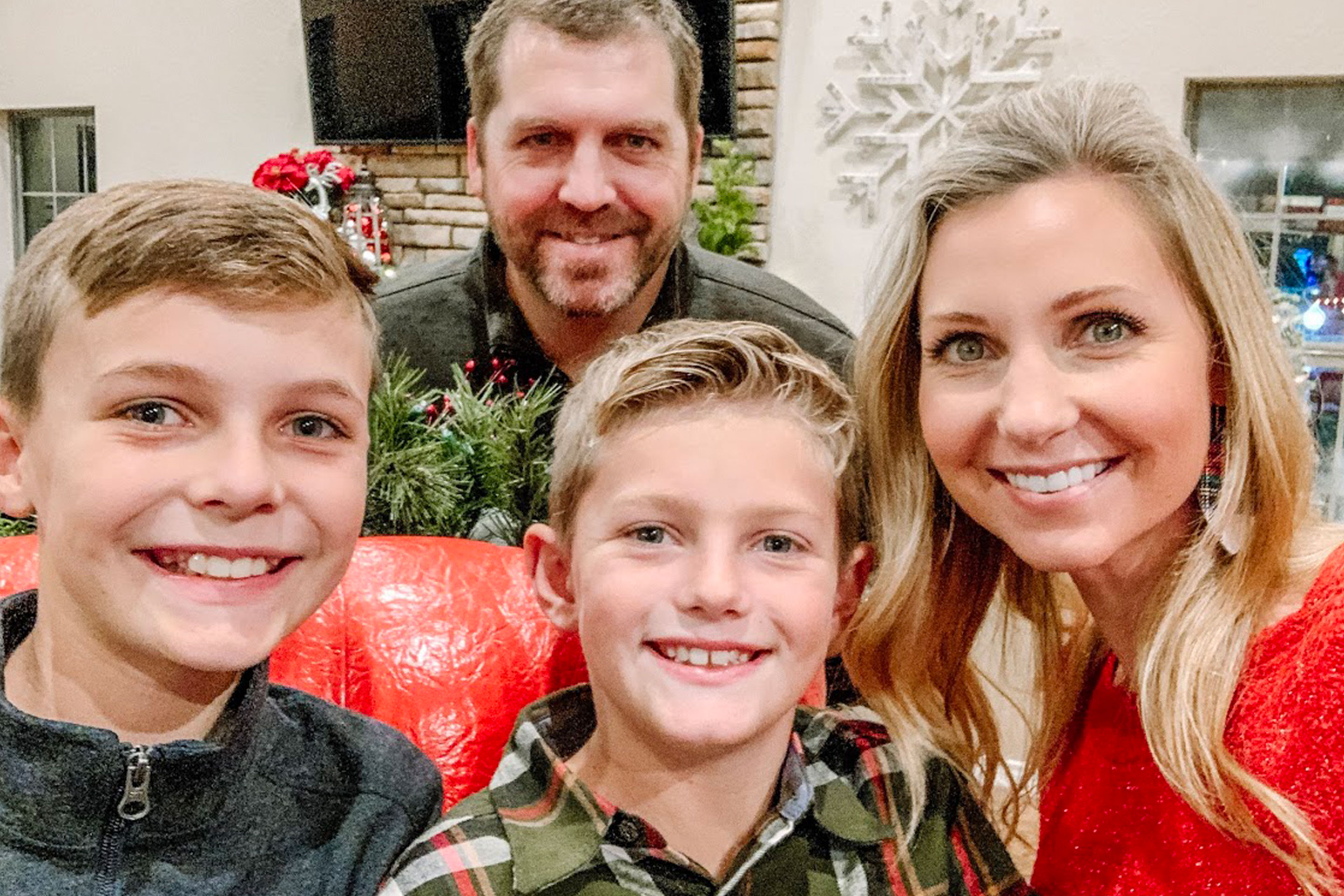 Author, Amanda Nall (right), and her family pose for a photo surrounded by holiday decor.