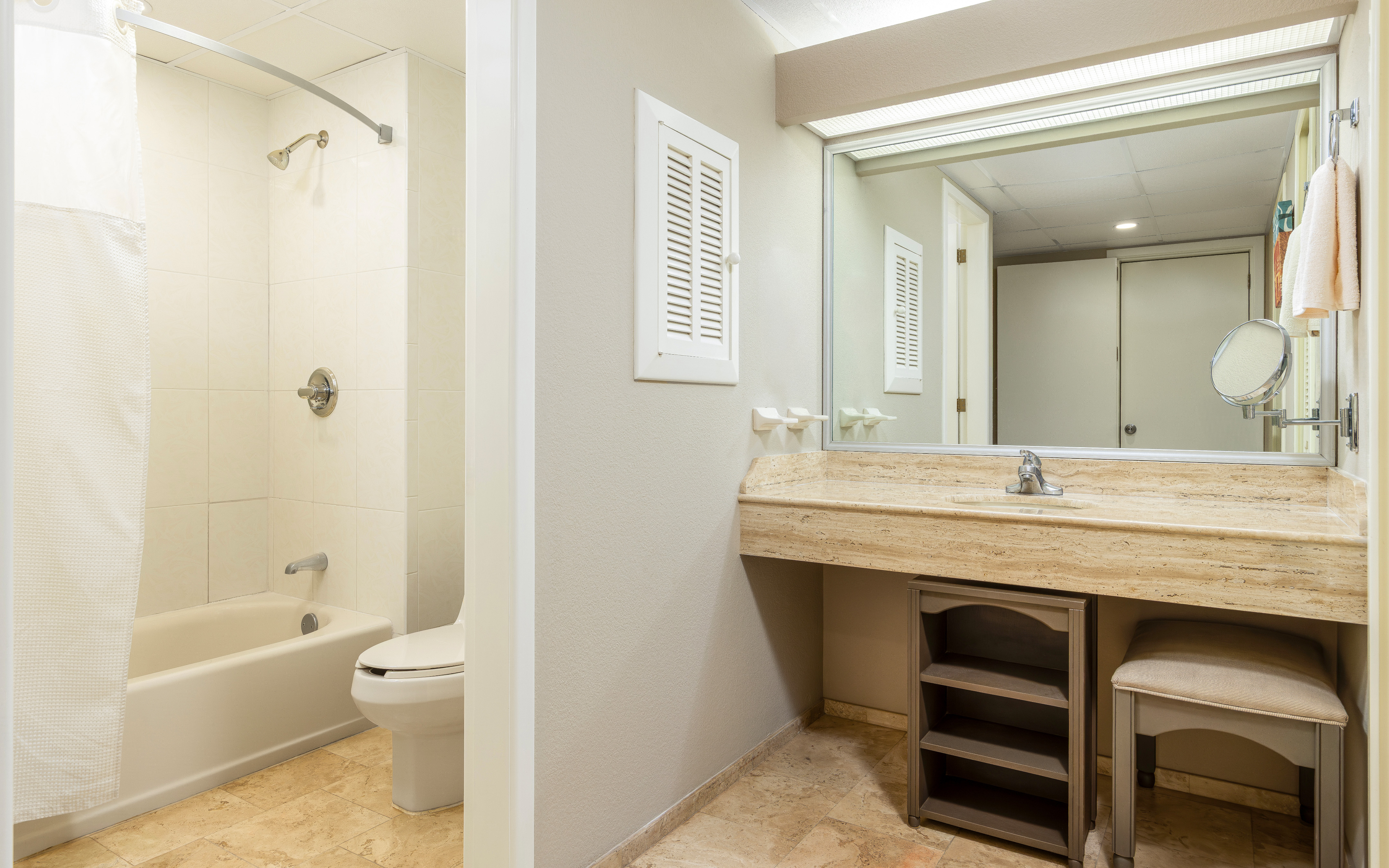 Spacious bathroom with granite vanity and tub-shower combo.
