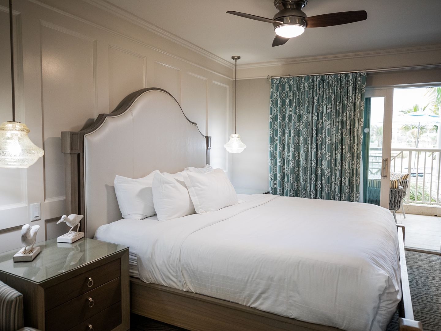 Bedroom with access to balcony in a two-bedroom Signature Collection villa at Cape Canaveral Beach Resort.