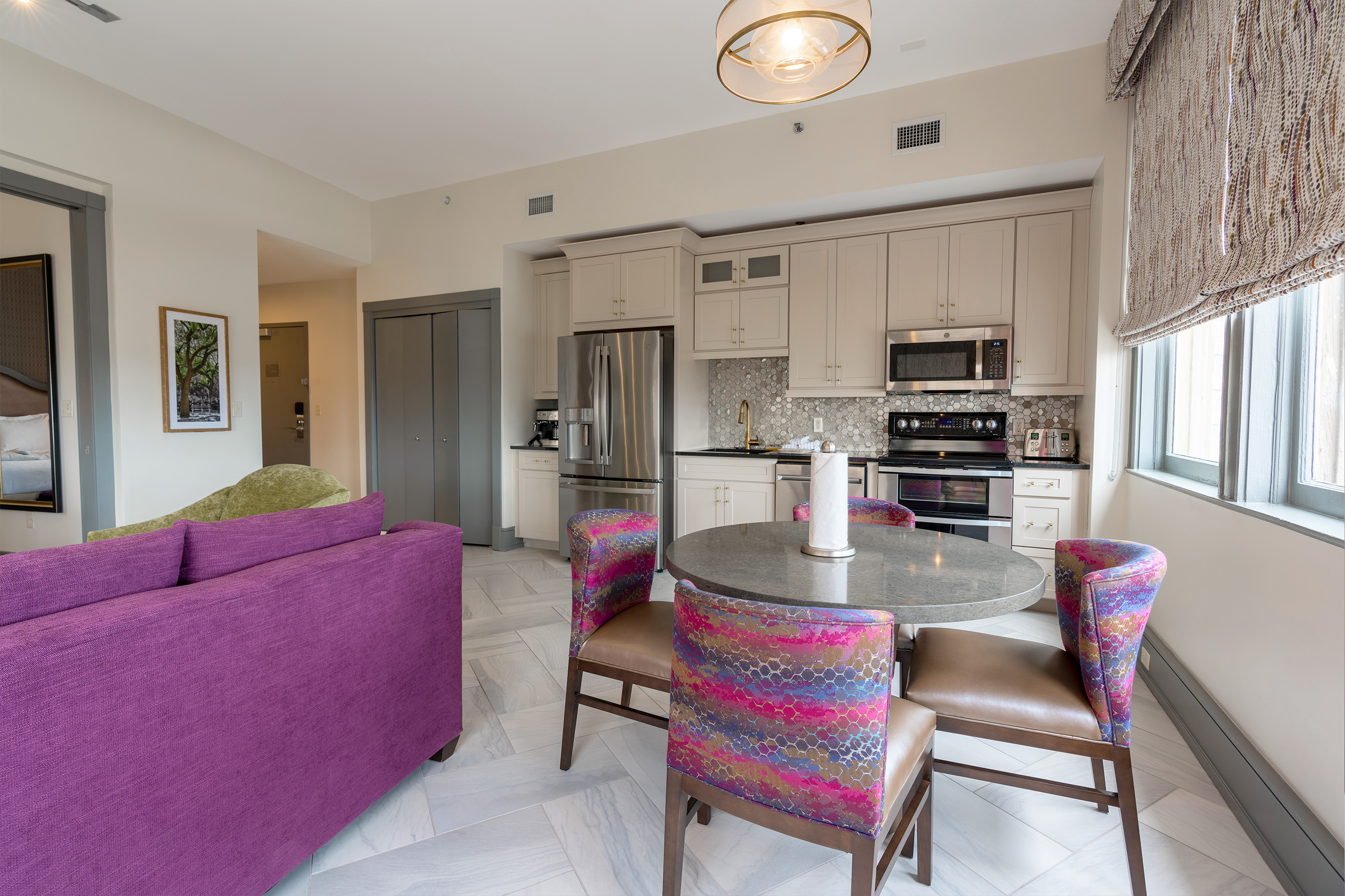Full kitchen with fridge, dishwasher, microwave and oven in a one-bedroom Signature Collection villa at New Orleans Resort in Louisiana.