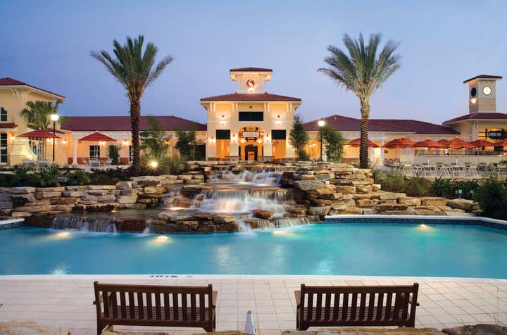 View of lazy river and The Exchange at night in River Island at Orange Lake Resort near Orlando, Florida