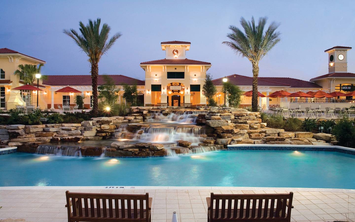 View of lazy river and The Exchange at night in River Island at Orange Lake Resort near Orlando, Florida