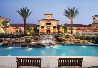 View of lazy river and The Exchange at night in River Island at Orange Lake Resort near Orlando, Florida