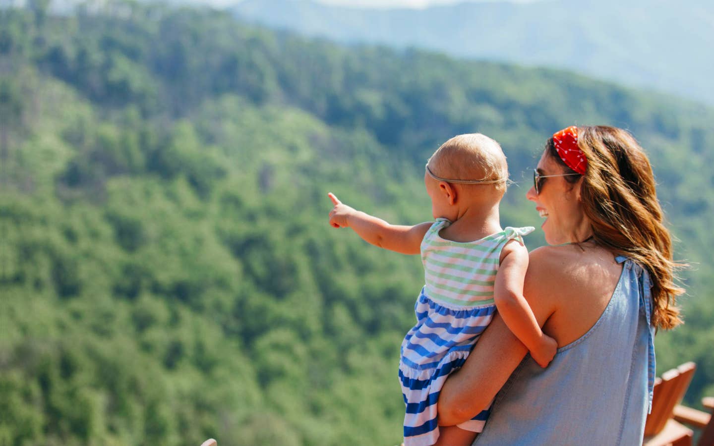 A mother hods her daughter while overlooking the Great Smoky Mountains.