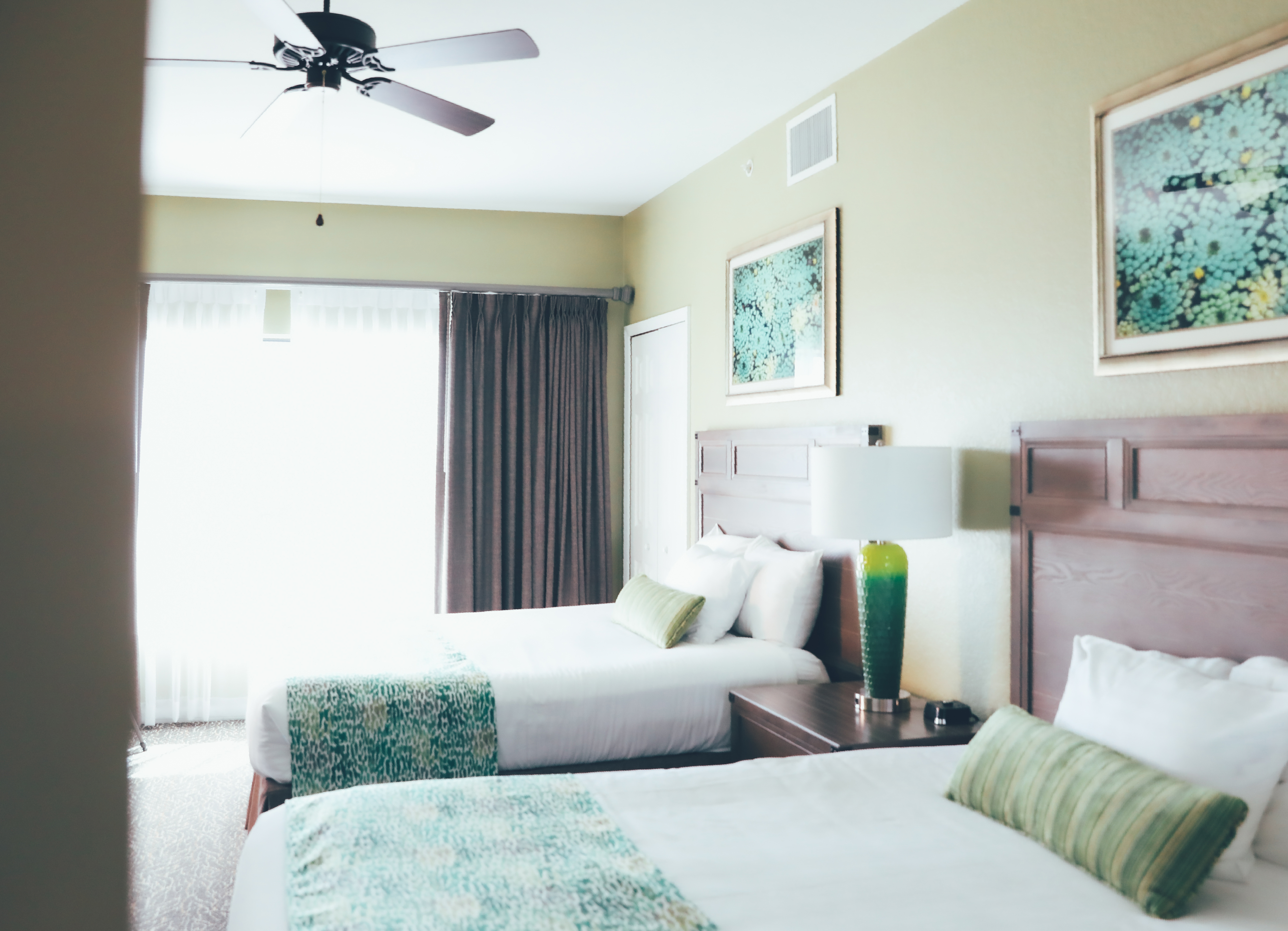 Two beds in a bedroom with large window in a villa in River Island at Orange Lake Resort near Orlando, Florida
