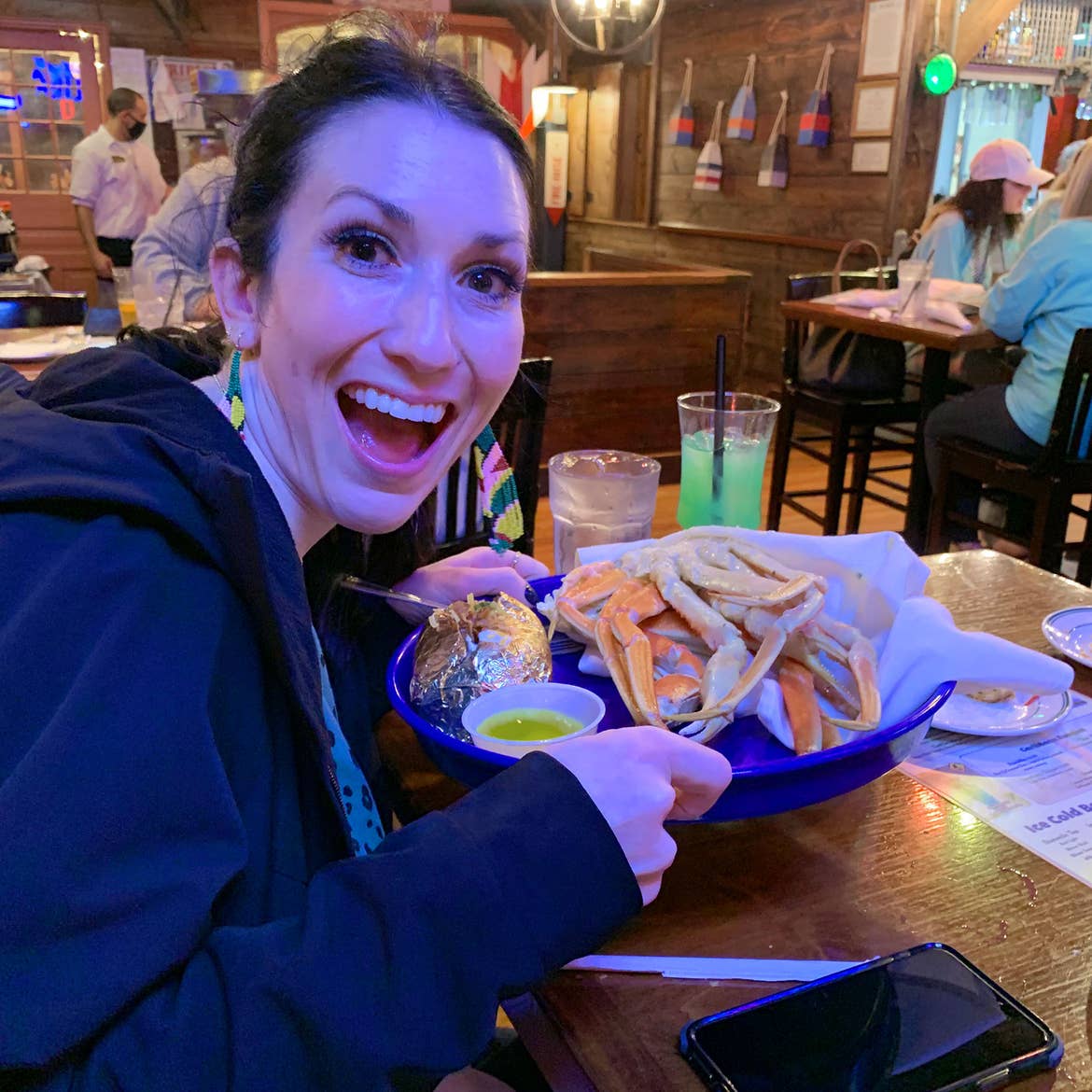 Featured Contributor, Amanda Nall's friend holds her Crab's Legs ordered at Fish Tales.