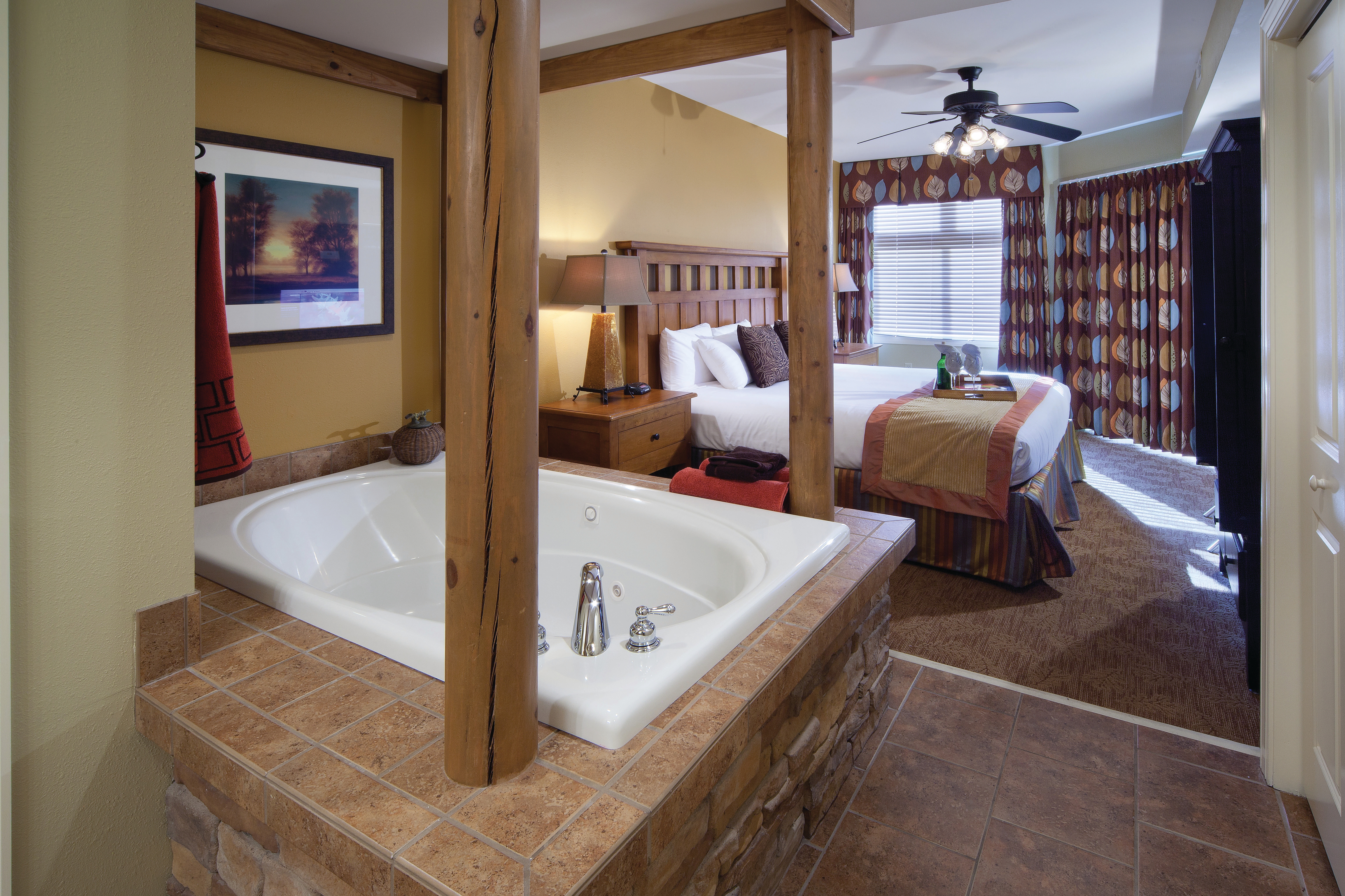 Bedroom with a bed and tub at Smoky Mountain Resort in Gatlinburg, Tennessee.