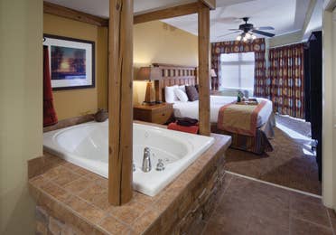 Bedroom with a bed and tub at Smoky Mountain Resort in Gatlinburg, Tennessee.
