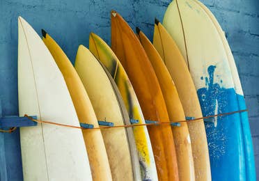Surfboards align against a blue wall at the Surf Museum in Cape Canaveral, FL
