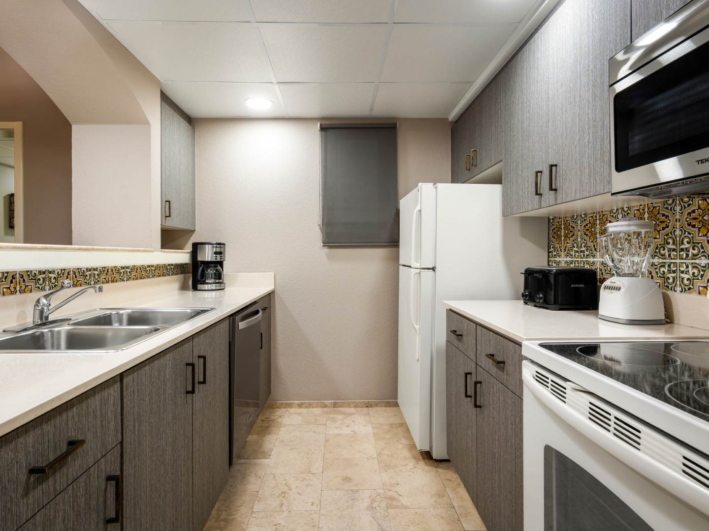 Full kitchen with sleek cabinets and essential appliances.