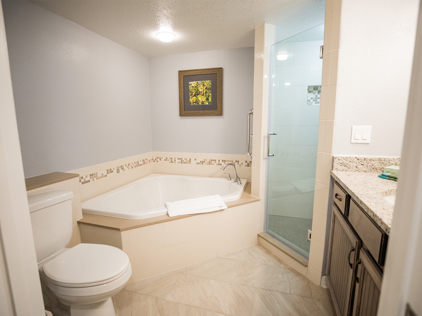 Bathroom with tub and walk-in shower in a villa at Cape Canaveral Beach Resort.
