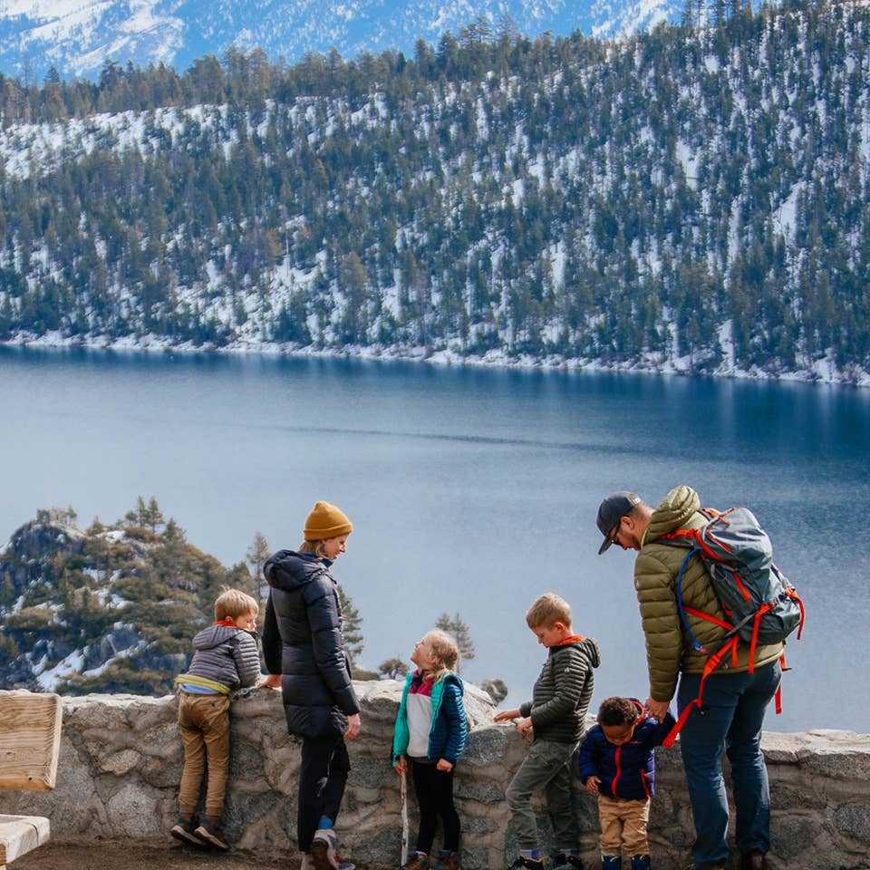 Andrea Rassmussen's family stands overlooking Emerald Bay State Park with a gorgeous forest, mountains and lake as a backdrop.