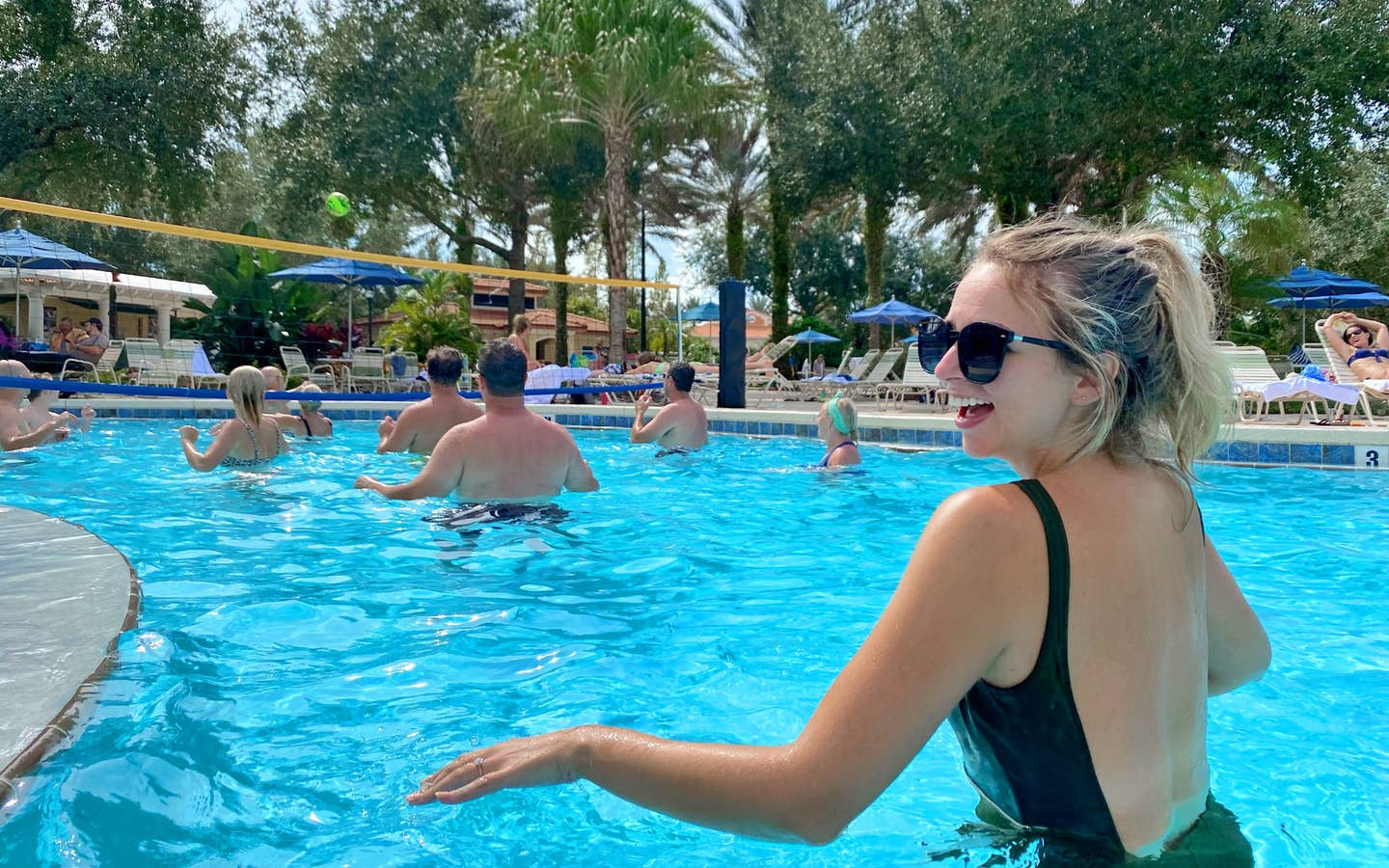 Featured Contributor, Angie Orth, wears a black swimsuit in the pool at our Orange Lake Resort in Orlando, Florida.