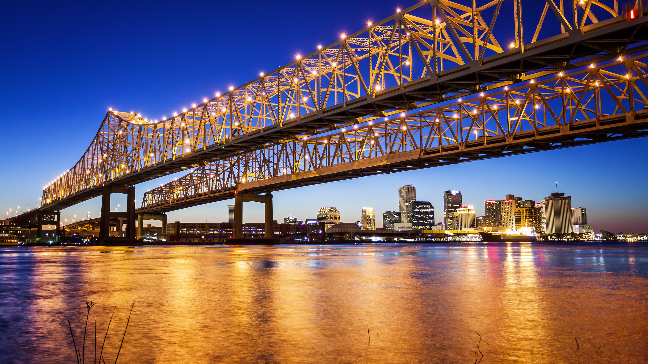 New Orleans bridge lit up at night.