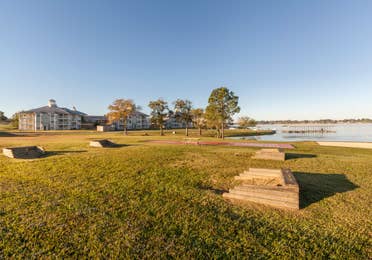 Outdoor shuffleboard court and two horseshoe games with a picnic table at Piney Shores Resort in Conroe, Texas.