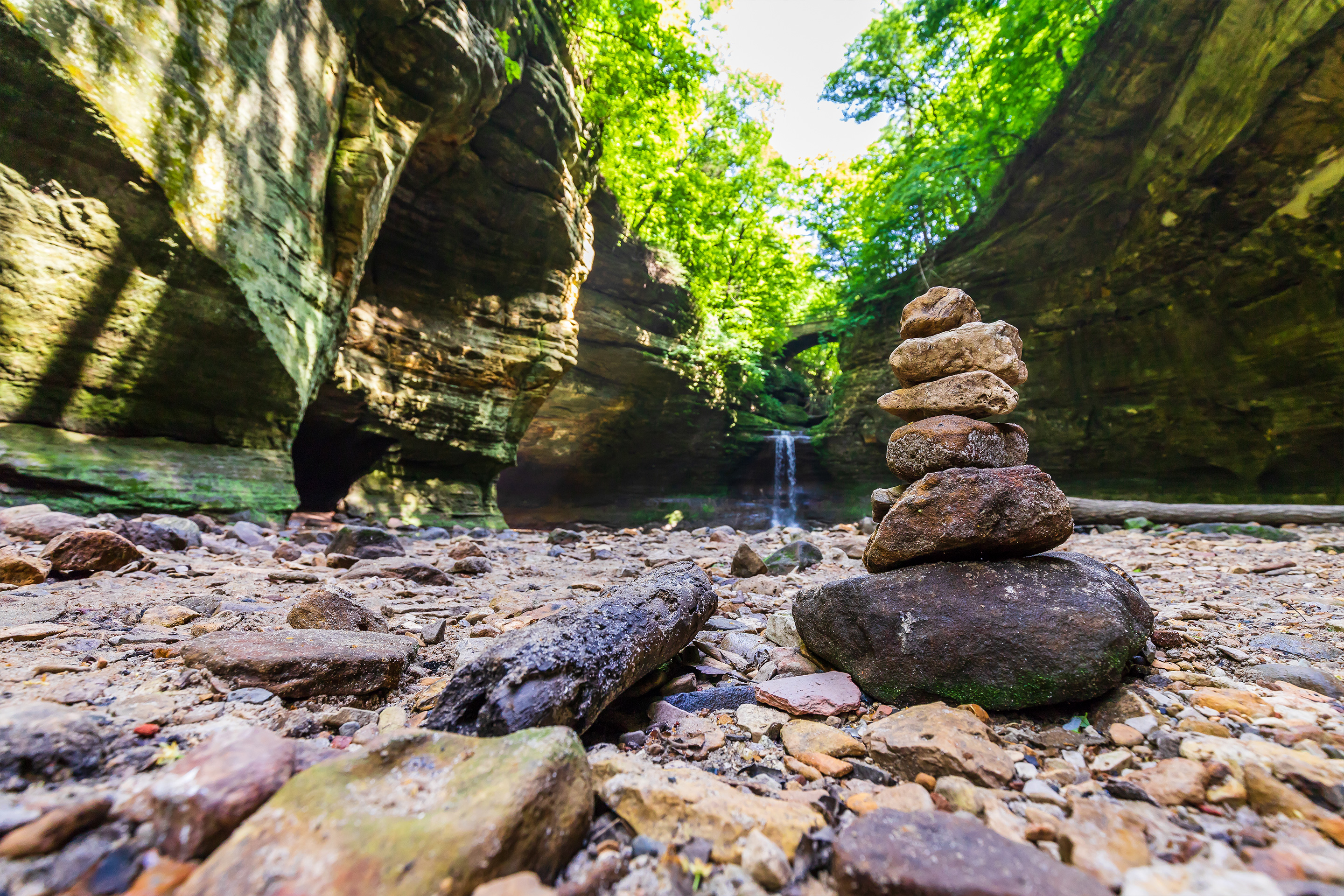 Pile of rocks stacked in front of a waterfall at Starved Rock State Park.