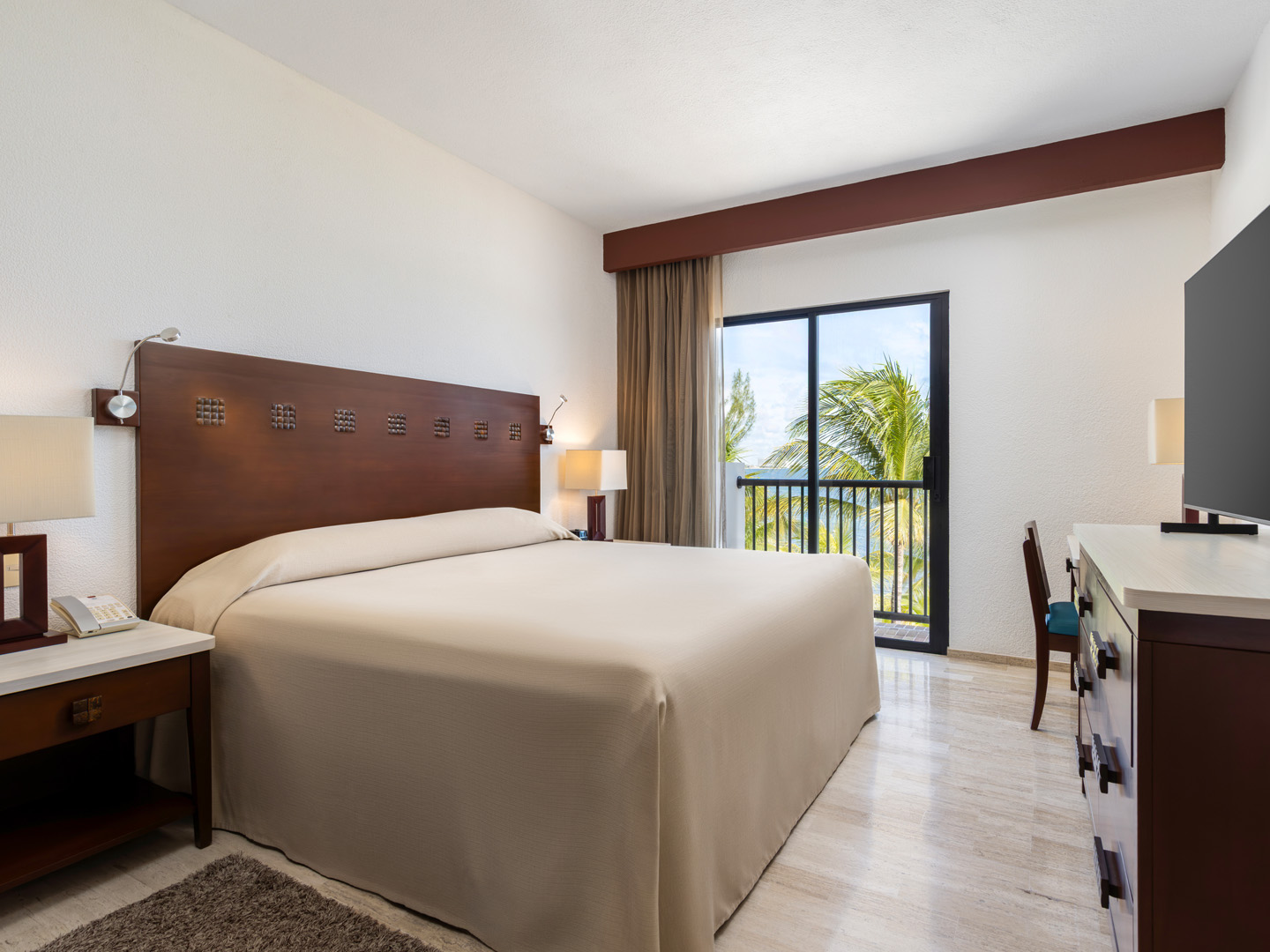 Spacious king bedroom with a balcony and ocean views.