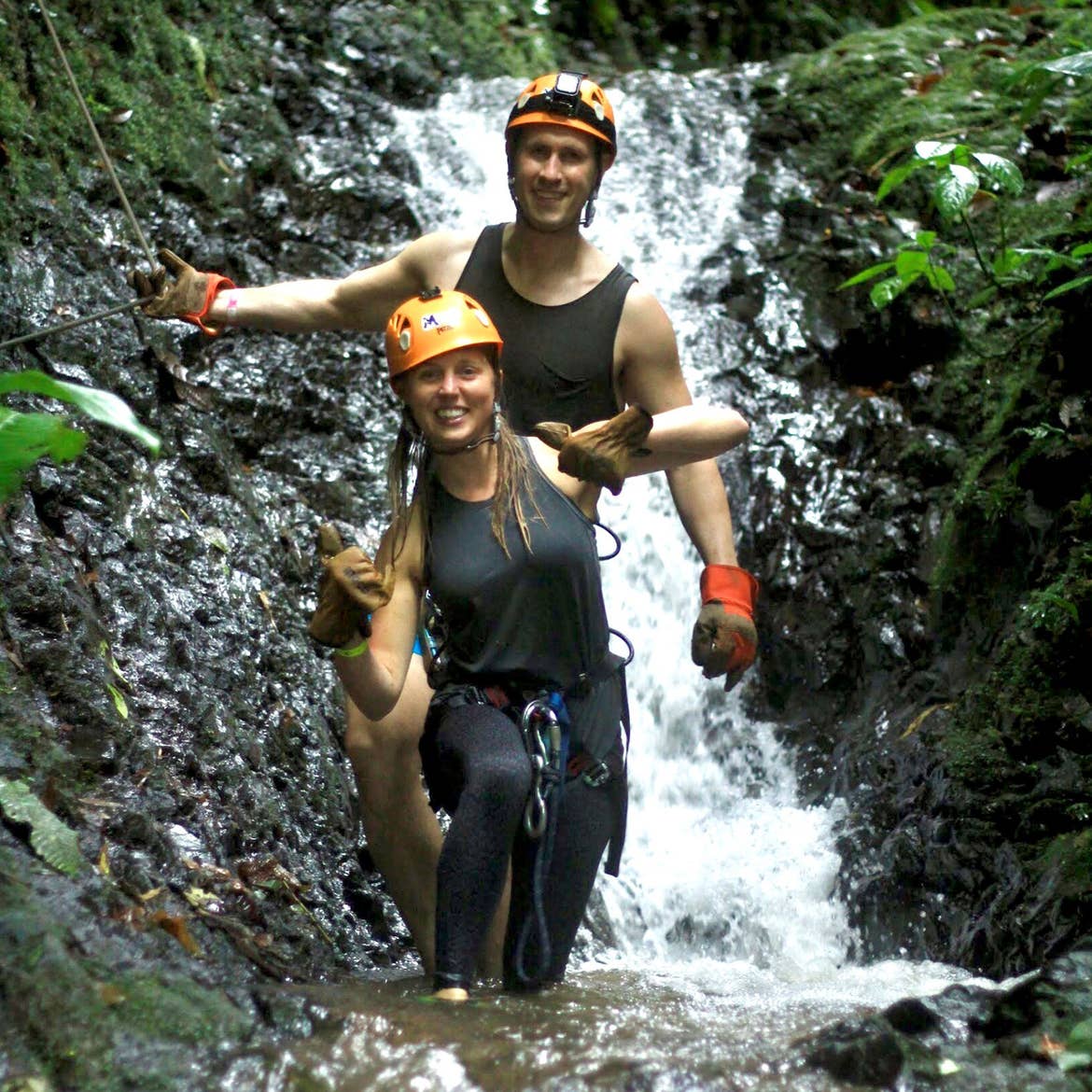 Featured contributor, Tiffany (front) and her husband (back) climb through a ravine in Costa Rica.