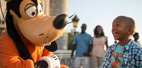Child at Disney's Magic Kingdom interacting with Goofy near Orange Lake Resort