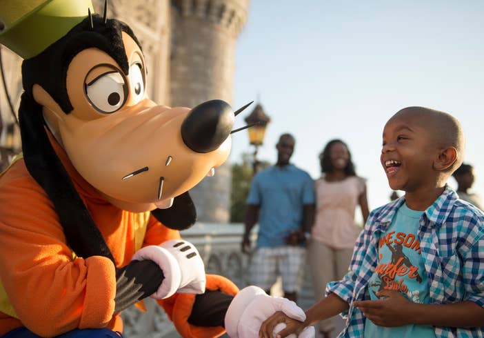 Child at Disney's Magic Kingdom interacting with Goofy near Orange Lake Resort