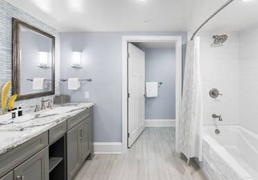 Bathroom with shower/tub combination in a four-bedroom Signature Collection villa at Cape Canaveral Resort.