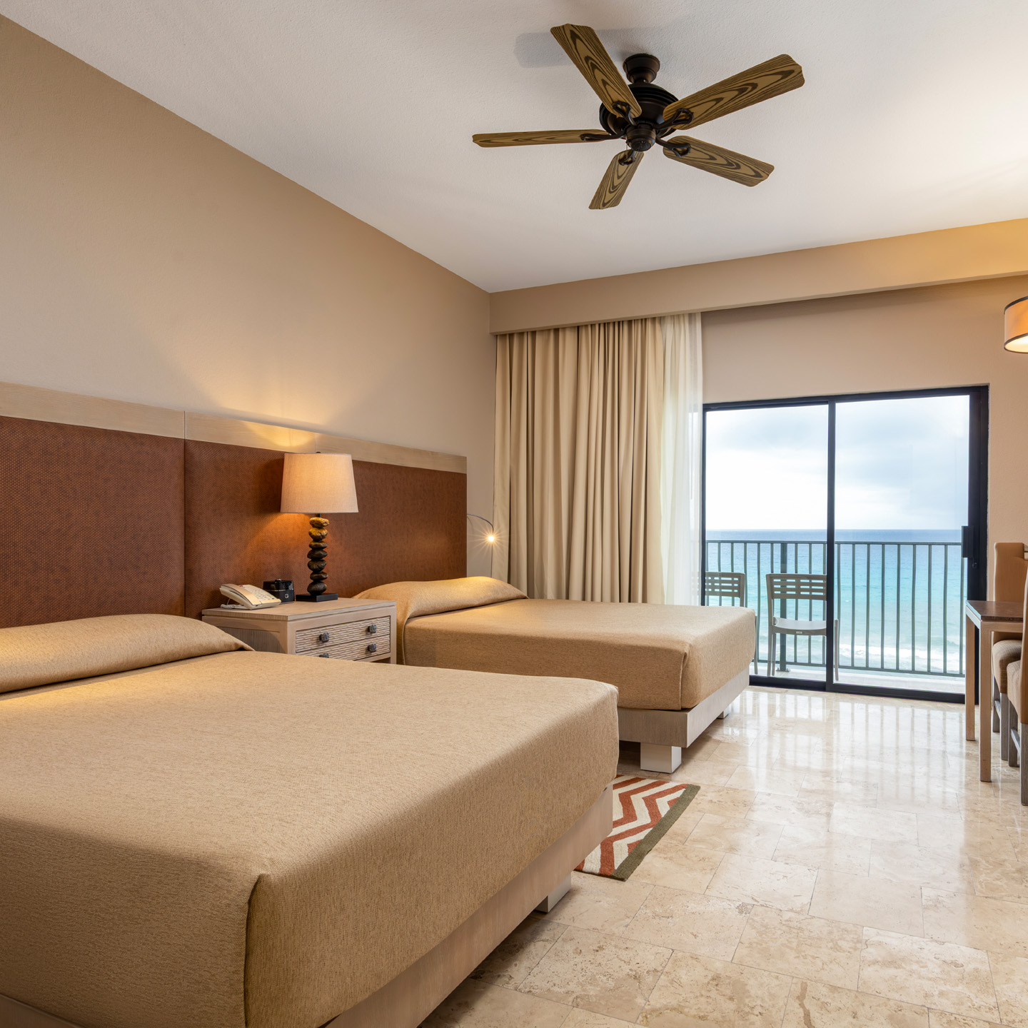 Bright oceanview living room with a dining area and balcony.