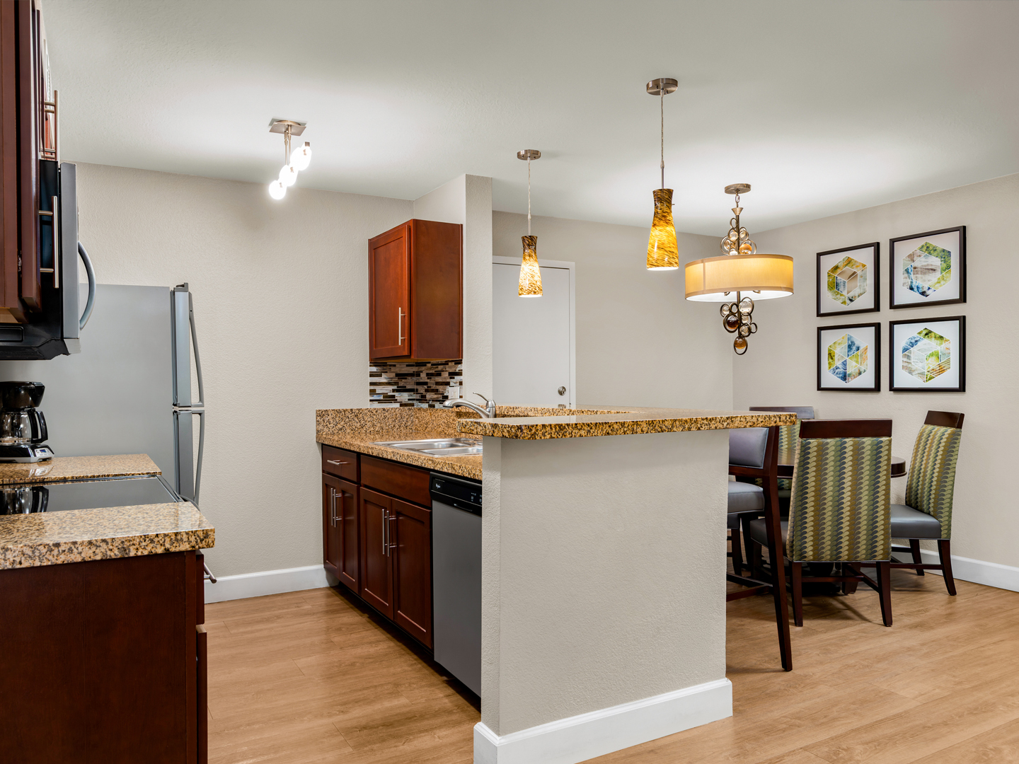 Spacious kitchen and dining area with modern finishes and lighting.