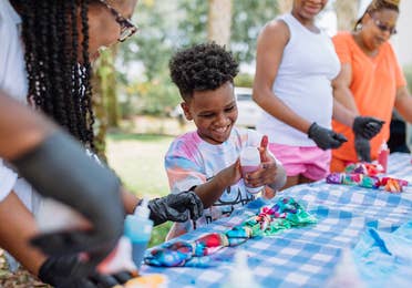 Family making tie dye shirts.