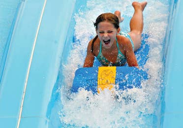 Child going down waterslide at Silver Dollar City near Holiday Hills Resort.