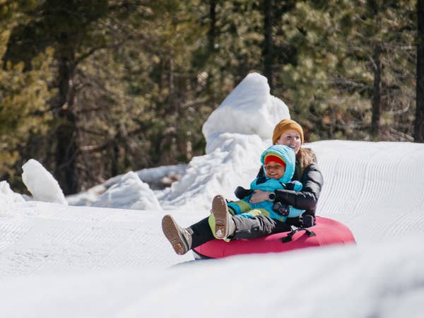 Mother and child snow tubing near Tahoe Ridge Resort in Stateline, Nevada.