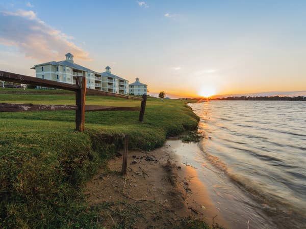 View of lake and property buildings at Piney Shores Resort in Texas.