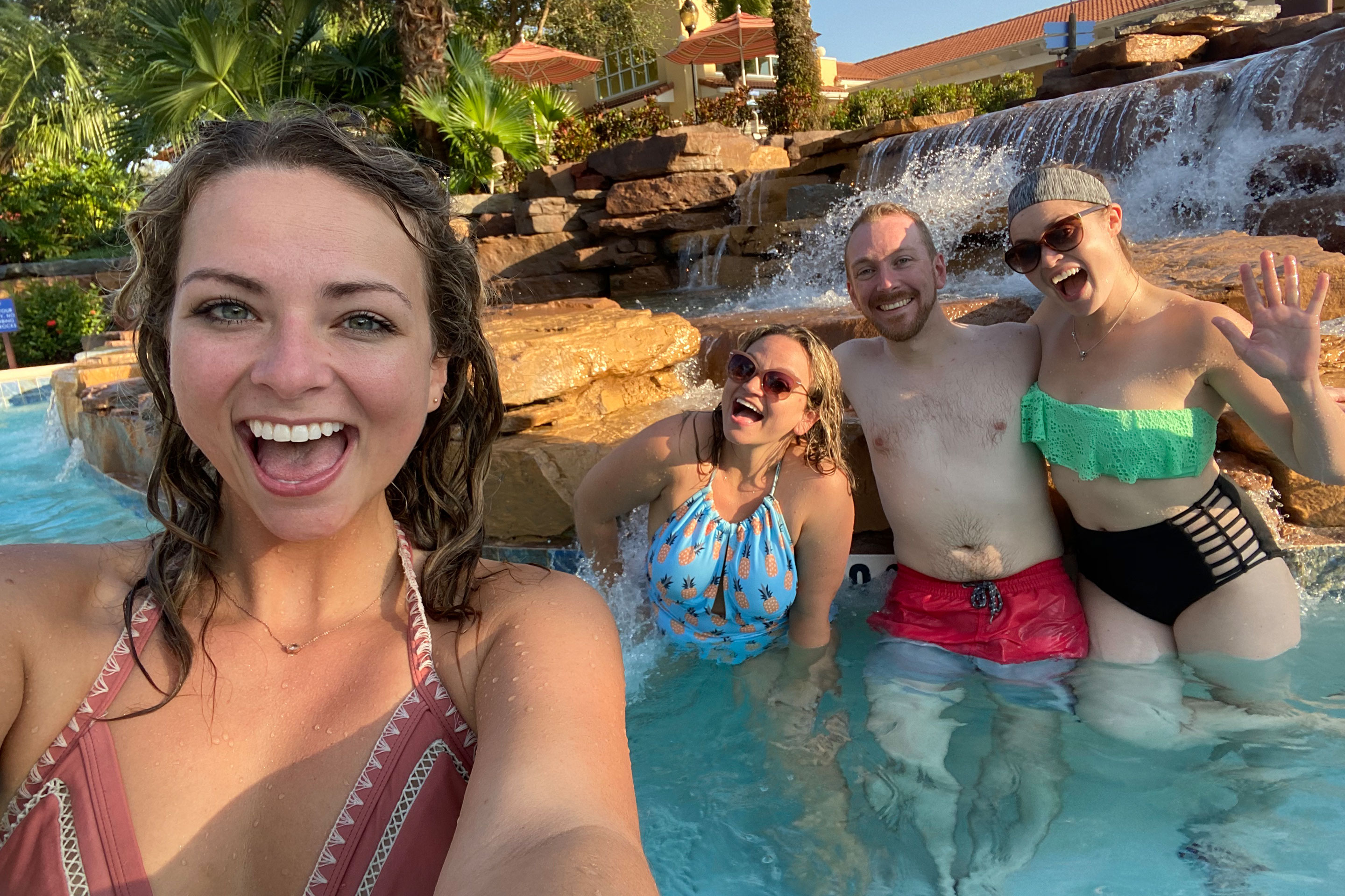 Featured Contributor, Angie Orth (left), and her sister and two friends (right) pose next to a water feature at river Island of Orange Lake Resort in Orlando, Florida.