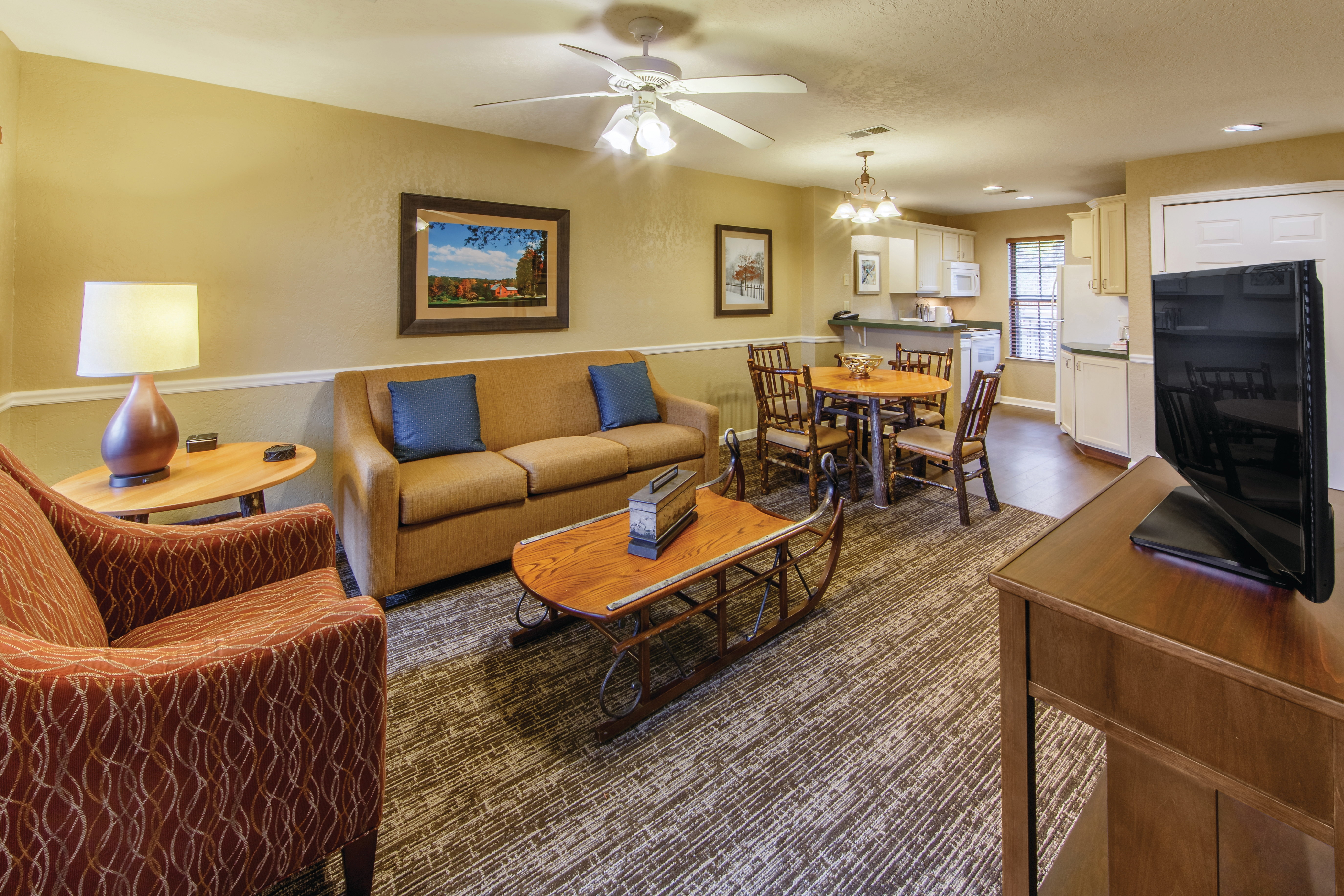 Family room with a view of the kitchen in a two bedroom villa at Oak n' Spruce Resort in South Lee, Massachusetts
