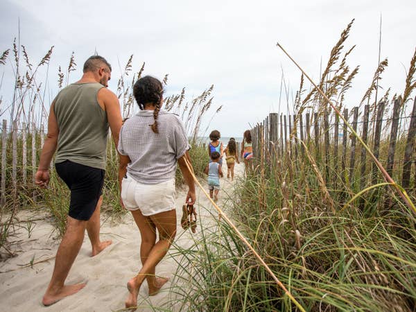 Family walking onto beach from South Beach Resort in Myrtle Beach, South Carolina