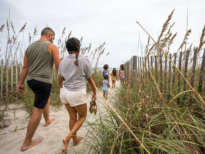 Family walking onto beach from South Beach Resort in Myrtle Beach, South Carolina