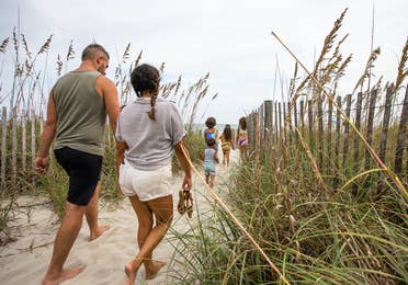 Family walking onto beach from South Beach Resort in Myrtle Beach, South Carolina