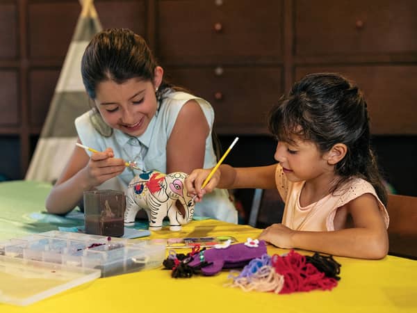 Girls painting an elephant at Royal Resorts in Mexico.