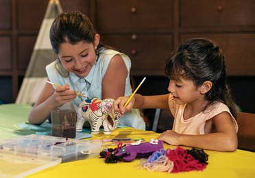 Girls painting an elephant at Royal Resorts in Mexico.