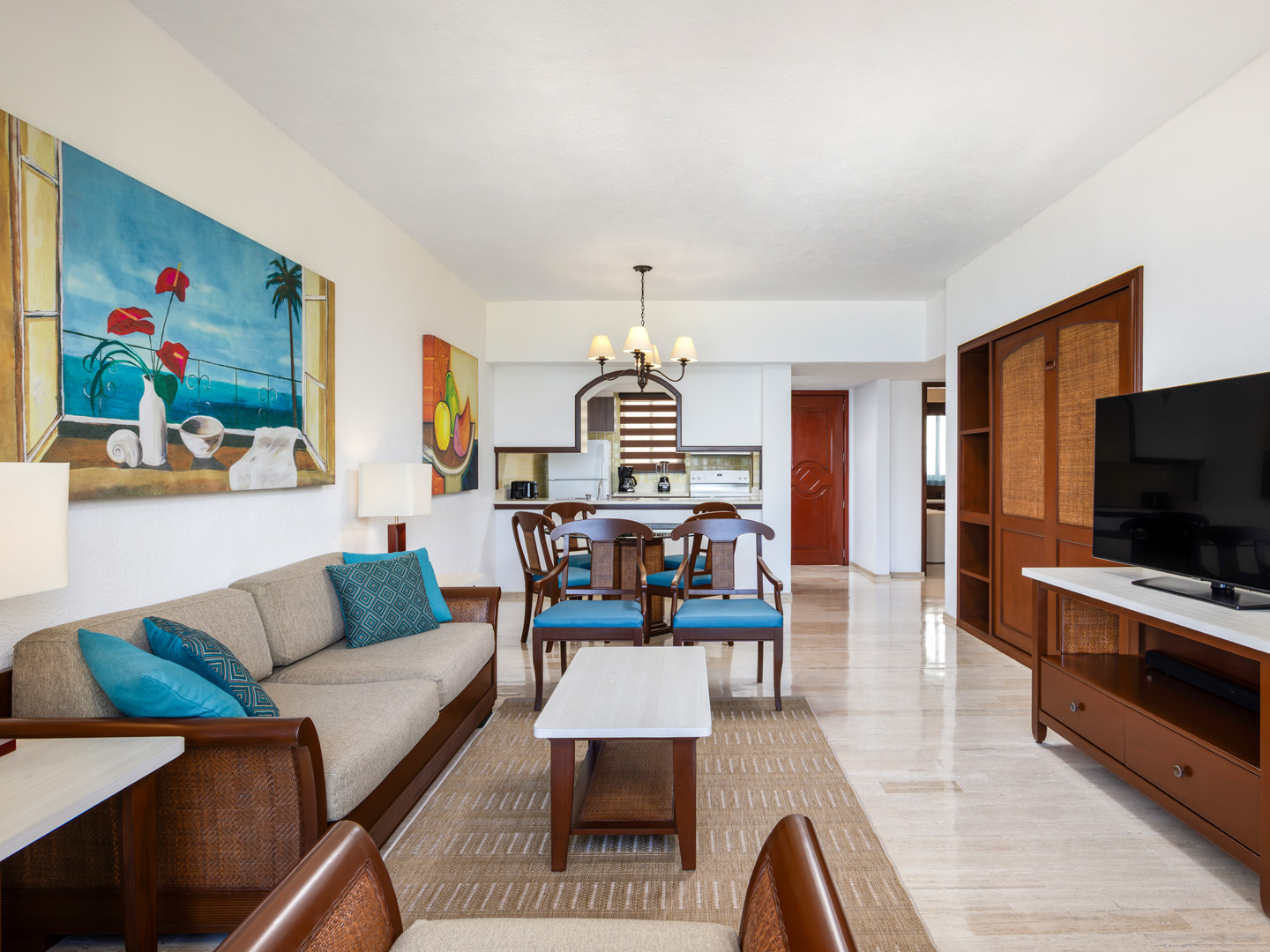 Suite living room with sofa, dining area, and TV. 