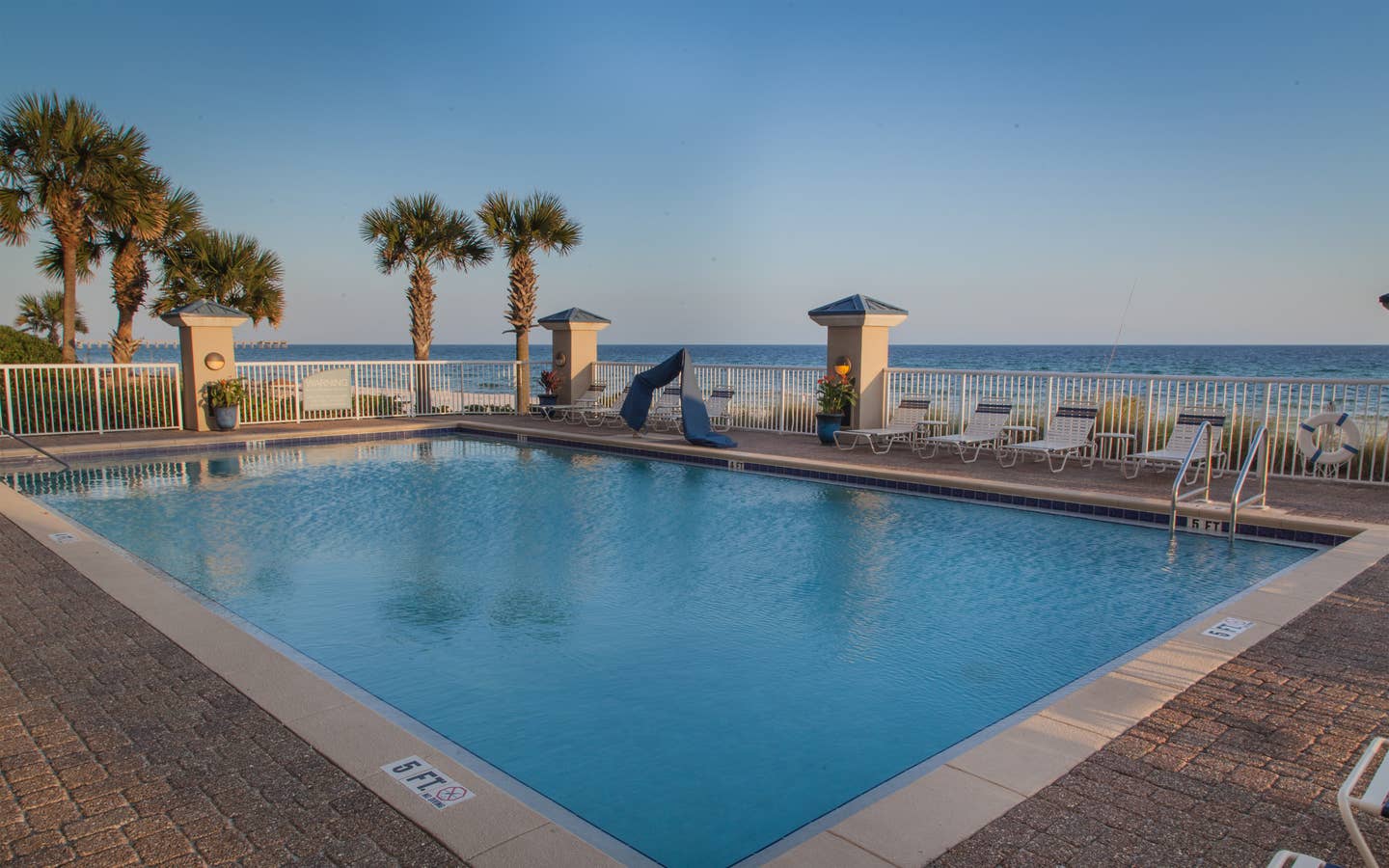 Outdoor pool with beach view at Panama City Beach Resort in Florida.