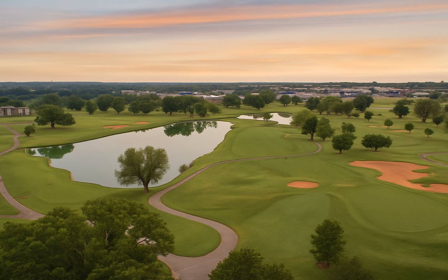 Aerial sunset view of Holiday Hills Resort championship golf course with lakes and fairways in Branson, Missouri
