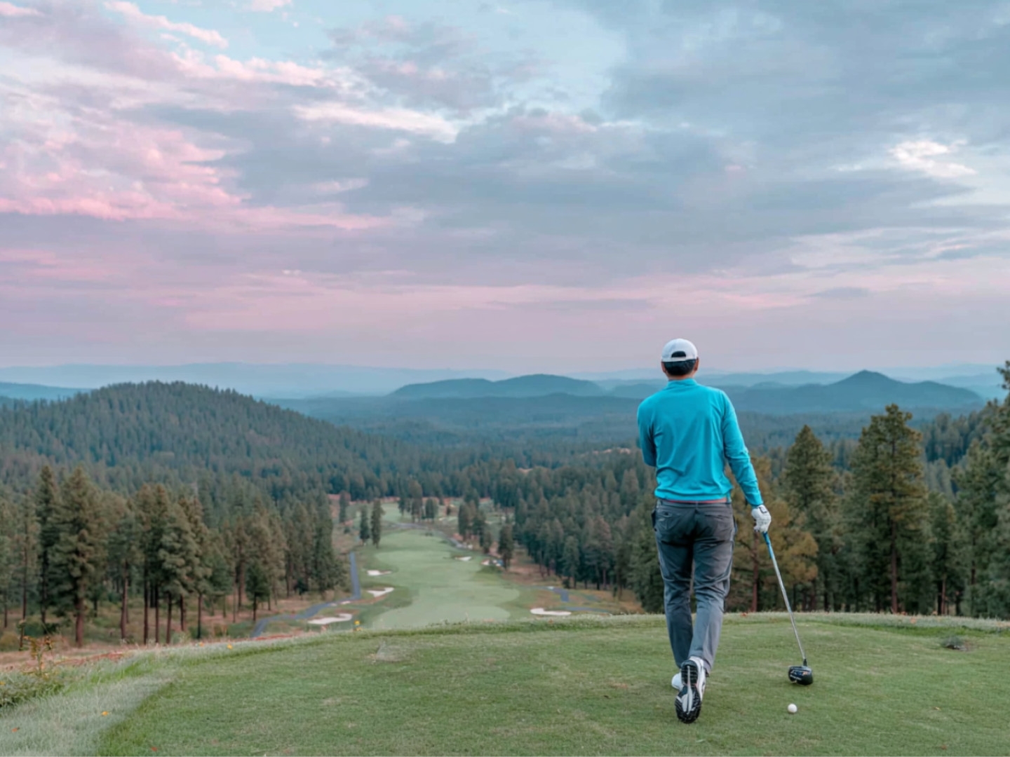 Golfer teeing off with stunning Ozark mountain views at Big Cedar Lodge’s Top of the Rock Golf Course.