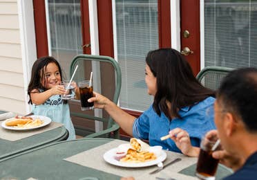 Family eating outdoors at Holiday Hills Resort in Branson, Missouri.